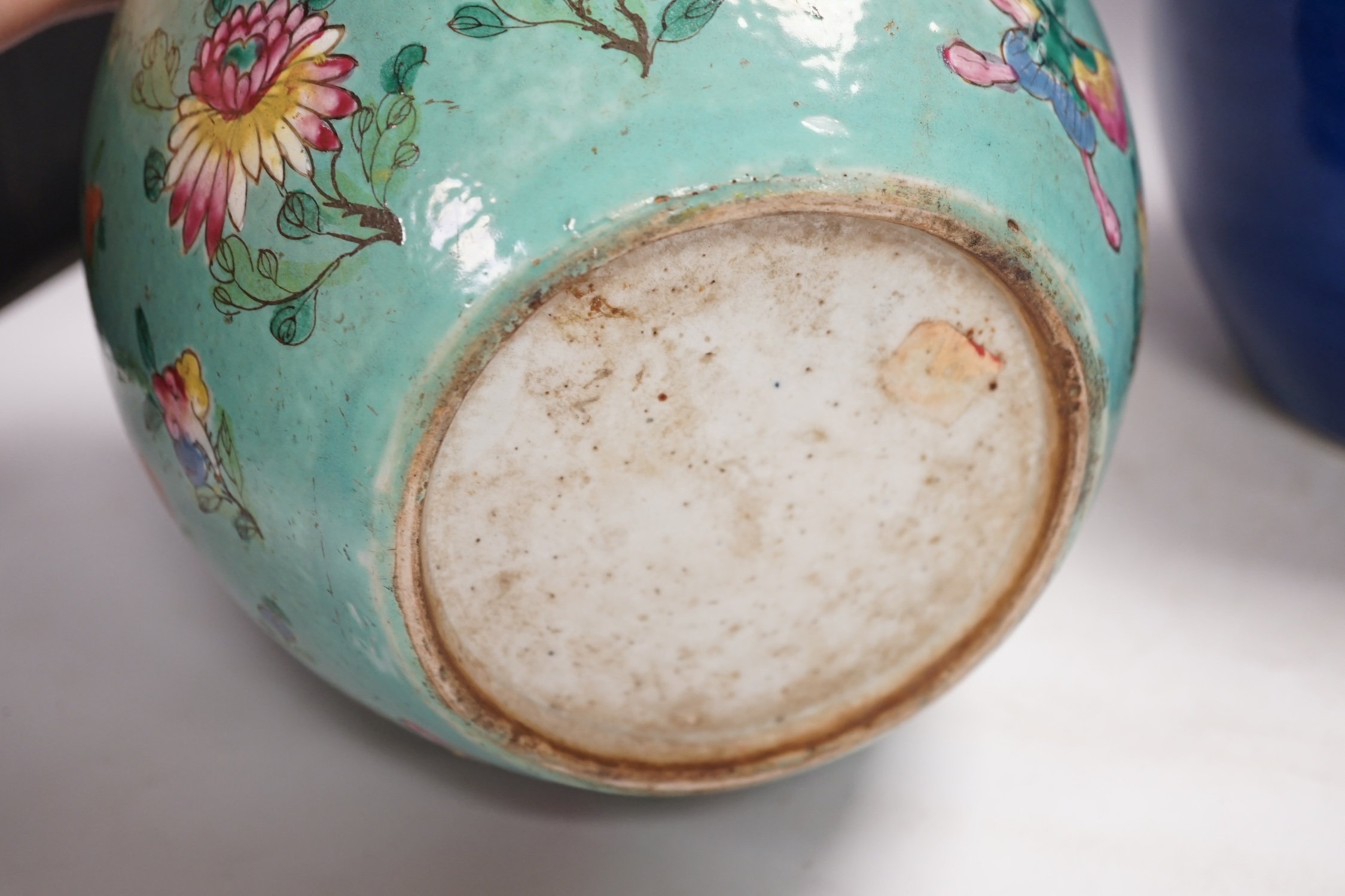 A Chinese powder blue jar, late 19th century, drilled hole to base and a turquoise glazed ground jar, blue vase 22cm high. Condition - turquoise jar cracked and chipped